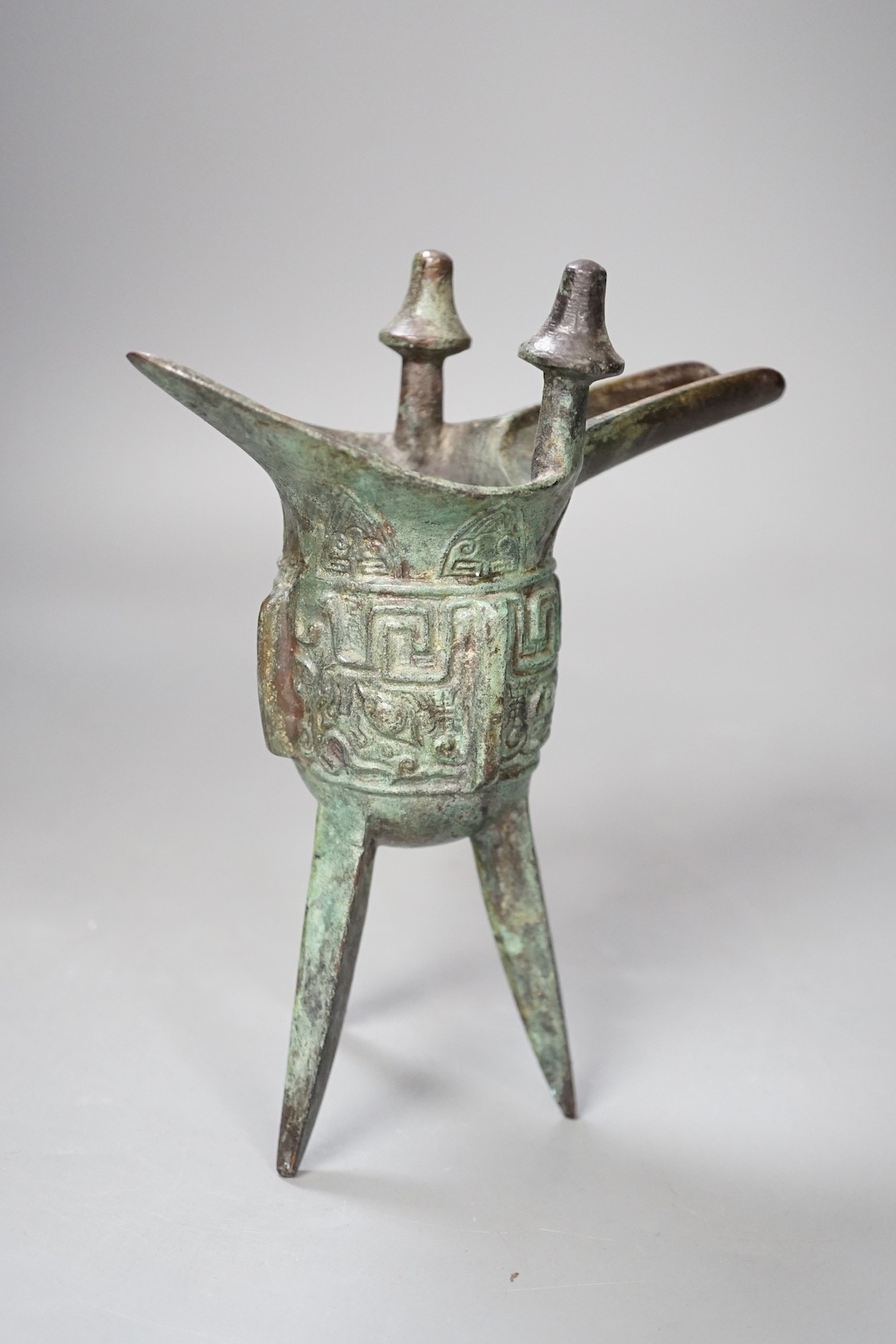 A Chinese jue archaistic bronze tripod vessel - 19.5cm tall
